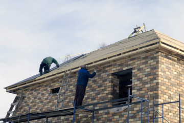 builders work at height at a construction site