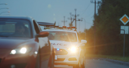 High speed police pursuit on highway. View of cop patrol car chasing a thief on red modern car driving away from the law. © Fractal Pictures