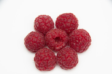 Red raspberries in the form of a hexagon on a white background