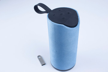 Wireless portable speaker for connecting to other device on a white background.