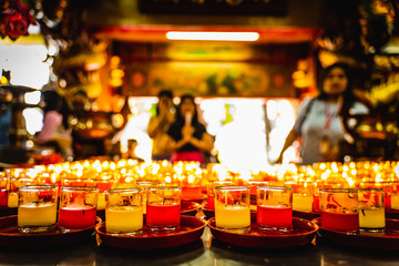 Lit Prayer Candles Close Up in Black Background. Hope and Successful Concept.