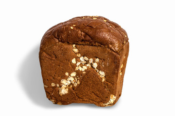 A loaf of rye cereal bread with oatmeal on a white background