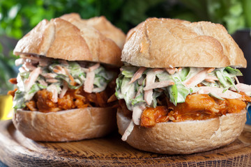 Pulled chicken sandwich with salad and bbq sauce