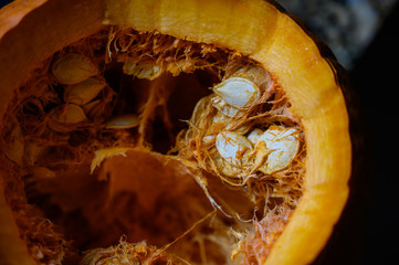 Top view looking into an open pumpkin with seeds