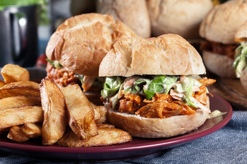 Pulled chicken sandwich with salad and bbq sauce