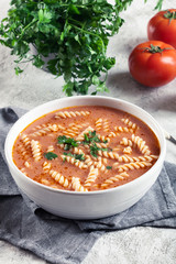 Tomato soup with fusilli pasta in the bowl