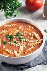 Tomato soup with fusilli pasta in the bowl