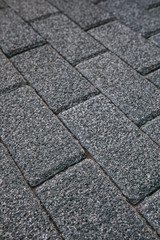 Gray Brick stone tiled street pavement road texture background.