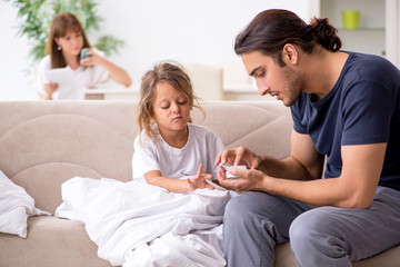 Father taking care of his ill daughter