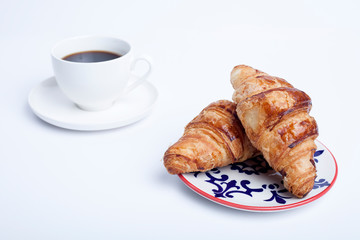 croissant and cup of coffee on a white background