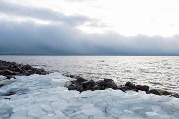 Natural background of ice. Large chunks of ice underfoot. Ice on the Bay.