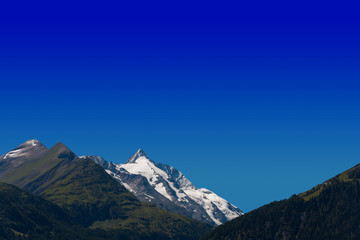 Fototapeta premium alpine peak of Grossglockner mountain in Austria. blue sky background for your text