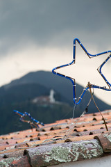 Star decorations on a roof against mountains