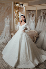Obraz premium Bride girl. Woman. Wedding fashion and beauty salon. Fashion model or princess at prom. Sexy girl in white dress with stylish hair. Full length photo of bride in wedding shop
