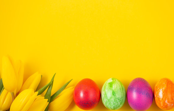 Beautiful group Easter eggs in the spring of easter day, red eggs, blue, purple and yellow on the Yellow background