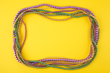 Mardi Gras beads background with place for text. Top view © vetre