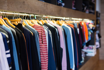 Different assortment of colorful clothing in boutique