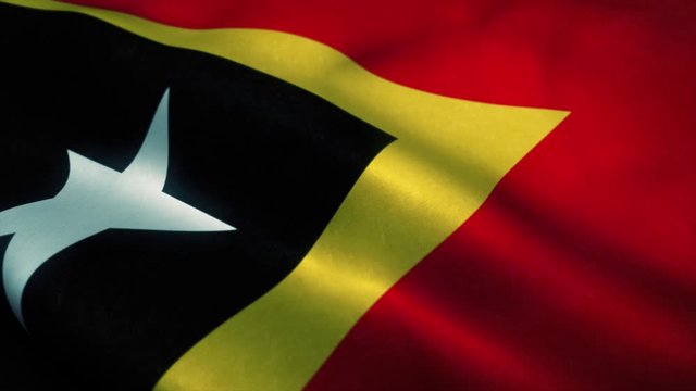 East Timor flag waving in the wind. National flag of East Timor. Sign of East Timor seamless loop animation. 4K