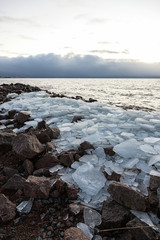 Natural background of ice. Large chunks of ice underfoot. Ice on the Bay.