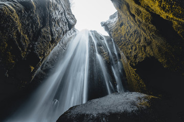 Gljufrabui - secret waterfall in Iceland. Amazing mystical hidden waterfall in cave.