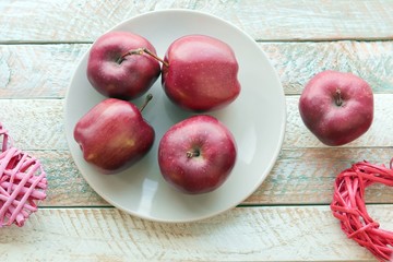 Valentines day, red apples, hearts on a wooden windowsill, decorate the interior for the holiday