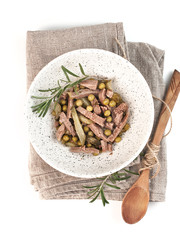 diet protein salad of boiled meat, green peas and pickled cucumbers, top view on a white background isolated