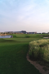 Fototapeta na wymiar Stunning panoramic view of the green golf course in Dubai, UAE 