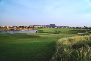 Fototapeta na wymiar Stunning panoramic view of the green golf course in Dubai, UAE 