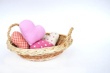 Fototapeta na wymiar Basket with decorative hearts isolated on a white background. Rural style. The concept of gifts and congratulations for the holidays. Copy space.