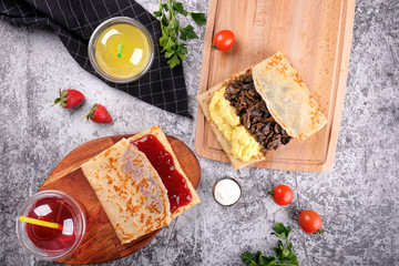 Shrovetide Maslenitsa. Traditional festival meal. Pancakes blini with meat and berry jam, flat lay...