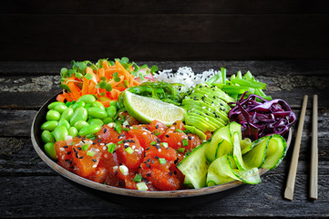 Vegan poke bowl with marinated watermelon, edamame, avocado, seaweed and carrot noodles