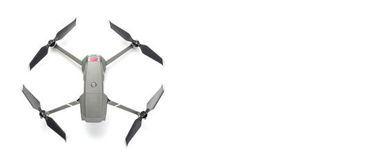 Modern drone quadcopter with a camera isolated on white background. Top view. Free space for your text