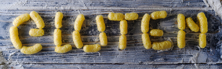 The words gluten-free corn stick products. Top view. Hypoallergenic products.