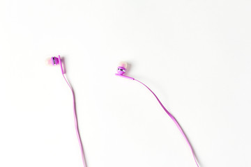 pink headphones on a white background. simple minimalistic composition with space for text