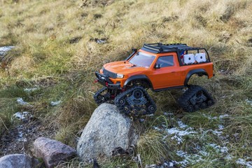 View of radio controlled model  racing car on off-road background. Toys with remote control. Free time. Children and adults concept.