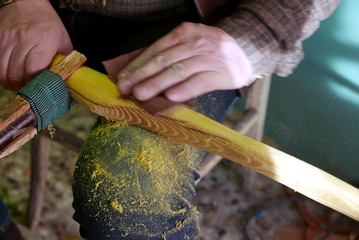 man smoothing wood