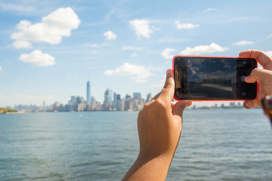 new york, usa. 19 th august, 2016: a tourist is taking a photography of manhattan with her mobile