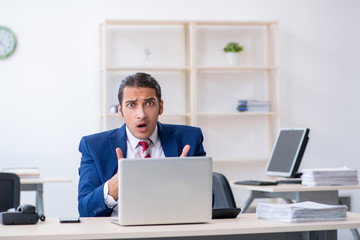 Young male businessman sitting in the office