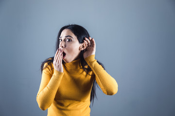 young beautiful woman hand in ear