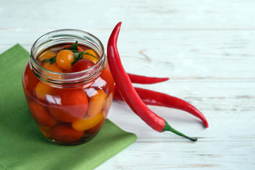 Fermented foods. Salted tomatoes in a glass jar on a white background. Vegetarian food. Super food.
