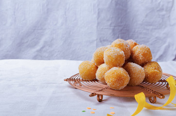 Traditional Carnival Italian fritters dusted sugar with honey and sprinkles.