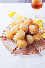 Traditional Carnival Italian fritters dusted sugar with honey and sprinkles.