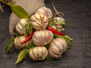 A beautiful bouquet of fresh garlic with red pepper and Bay leaves . Wrapped in coarse matting and...