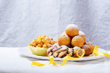 Traditional Carnival Italian fritters dusted sugar with honey and sprinkles.