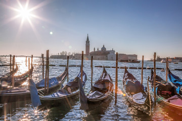 San Giorgio Maggiore Church with venetian gondolas at the harbor in Venice. Italy