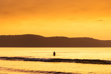 Fototapeta premium Summer Dawn Seascape and Swimmer Silhouette