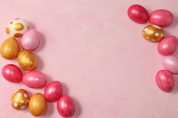 Decorated golden easter eggs on a pink background. Minimal holiday concept. Happy easter...