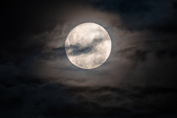Fototapeta na wymiar Full moon amongst the clouds