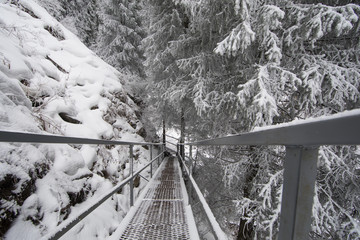 bridge over the river in the mountains in winter