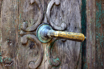 copper handle on an old wooden door